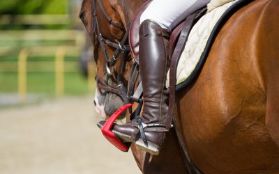 Jockey riding boot in the stirrup Leg rider in the stirrups.